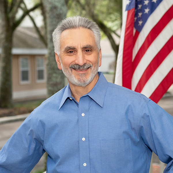 John D. Campo, Attorney with American flag in the background